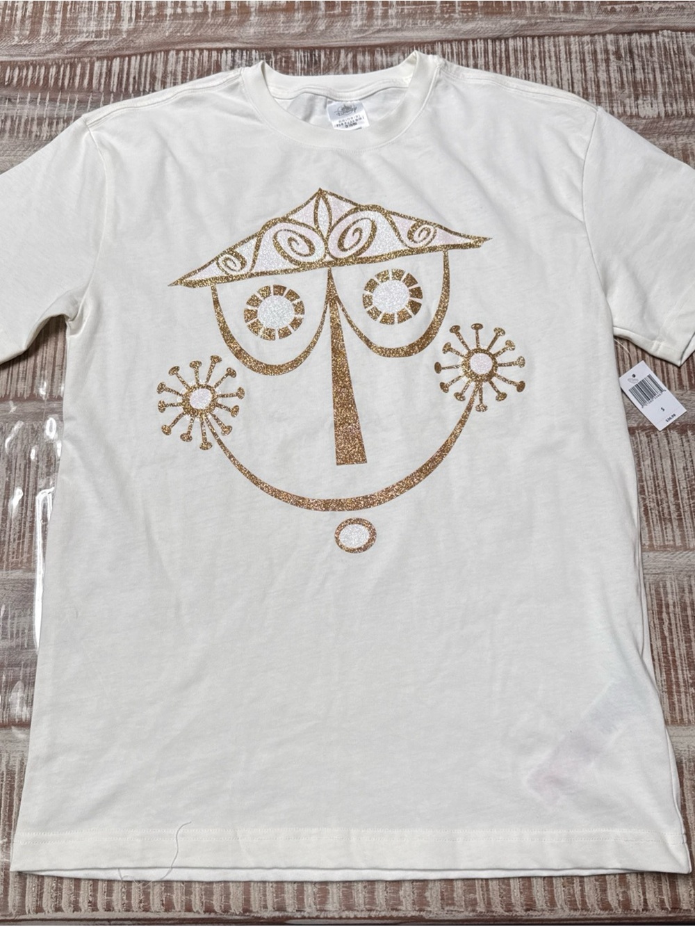 Disney off-white Tee with Gold Glitter it’s a small world Graphic NEW